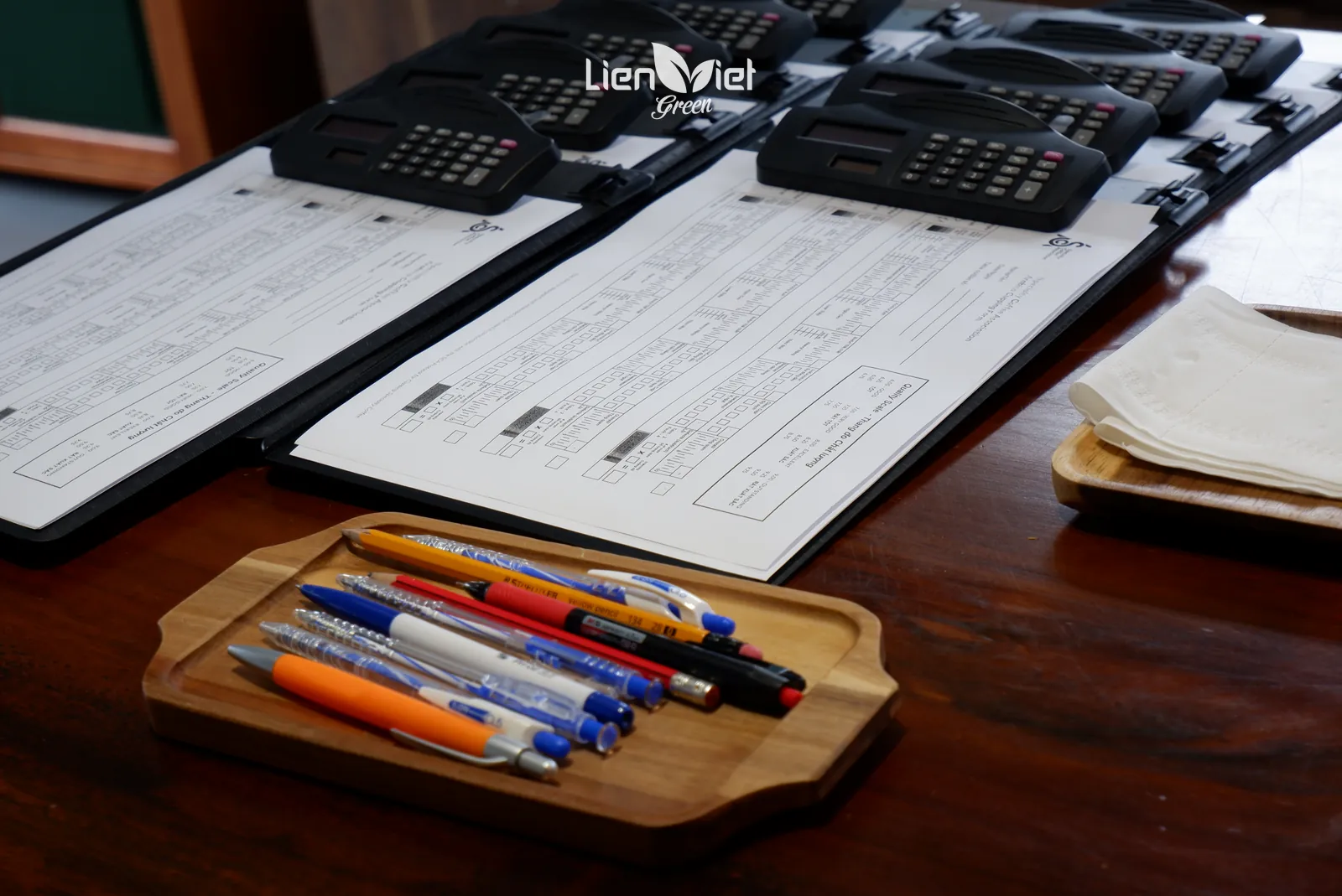 Cupping score sheets, calculator and pens ready for a sample evaluation