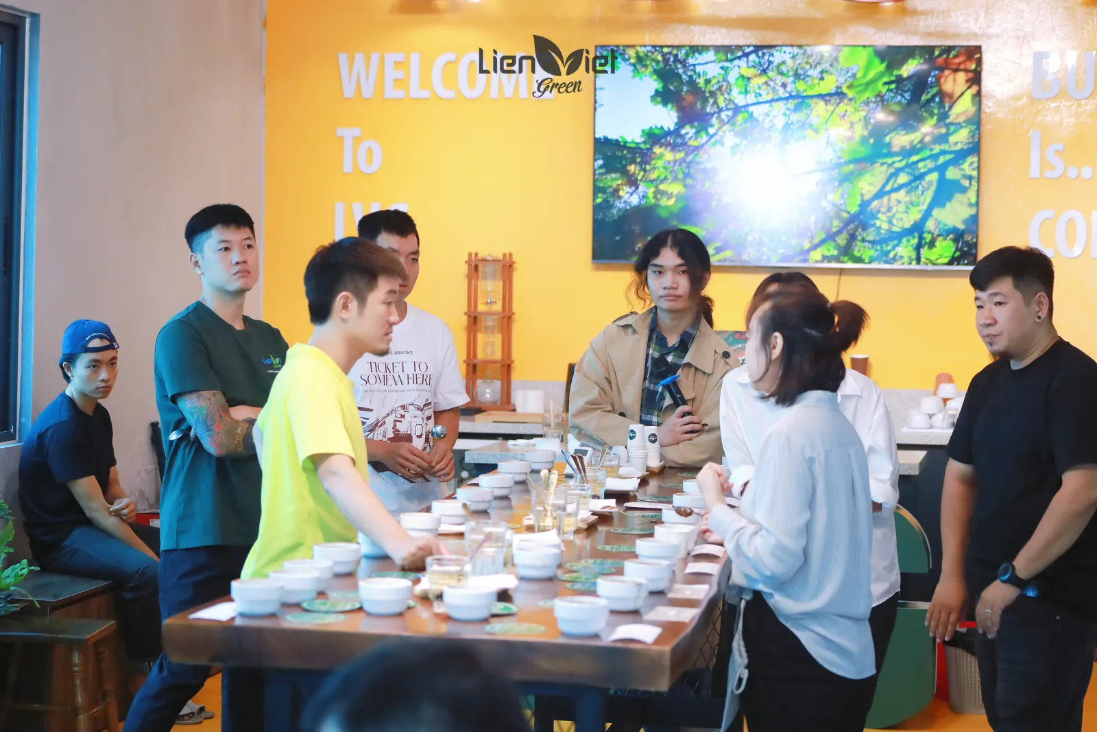Guests tasting around the cupping table at the roastery