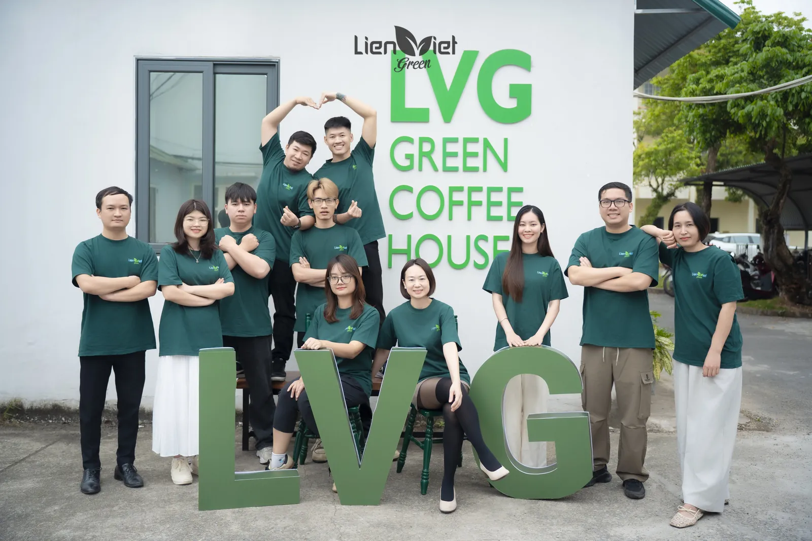 Đội ngũ LVG tạo dáng vui cùng chữ LVG lớn trước tường Green Coffee House