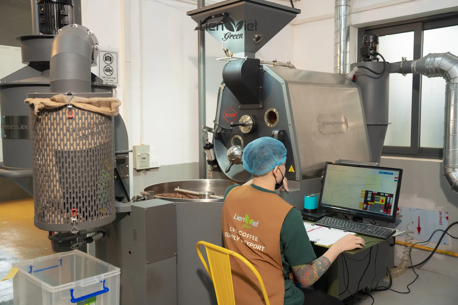 LVG roaster monitoring the control computer beside the roaster